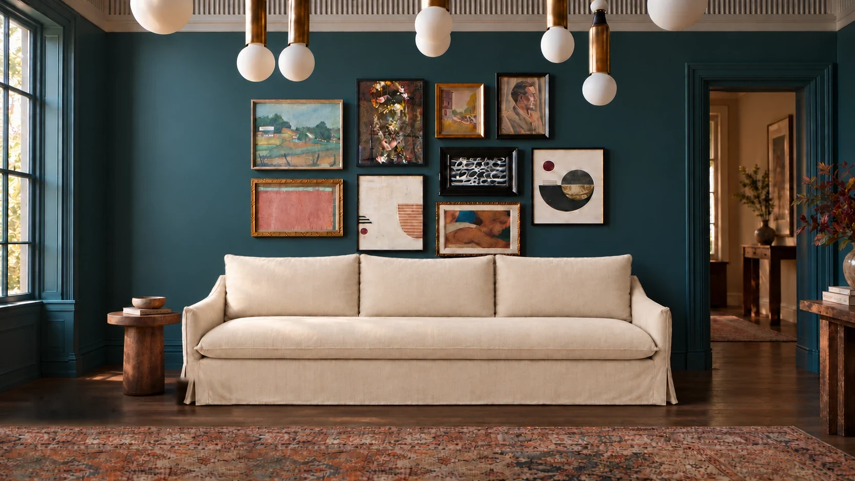 Ellis slipcover 3-seater sofa against a teal gallery wall